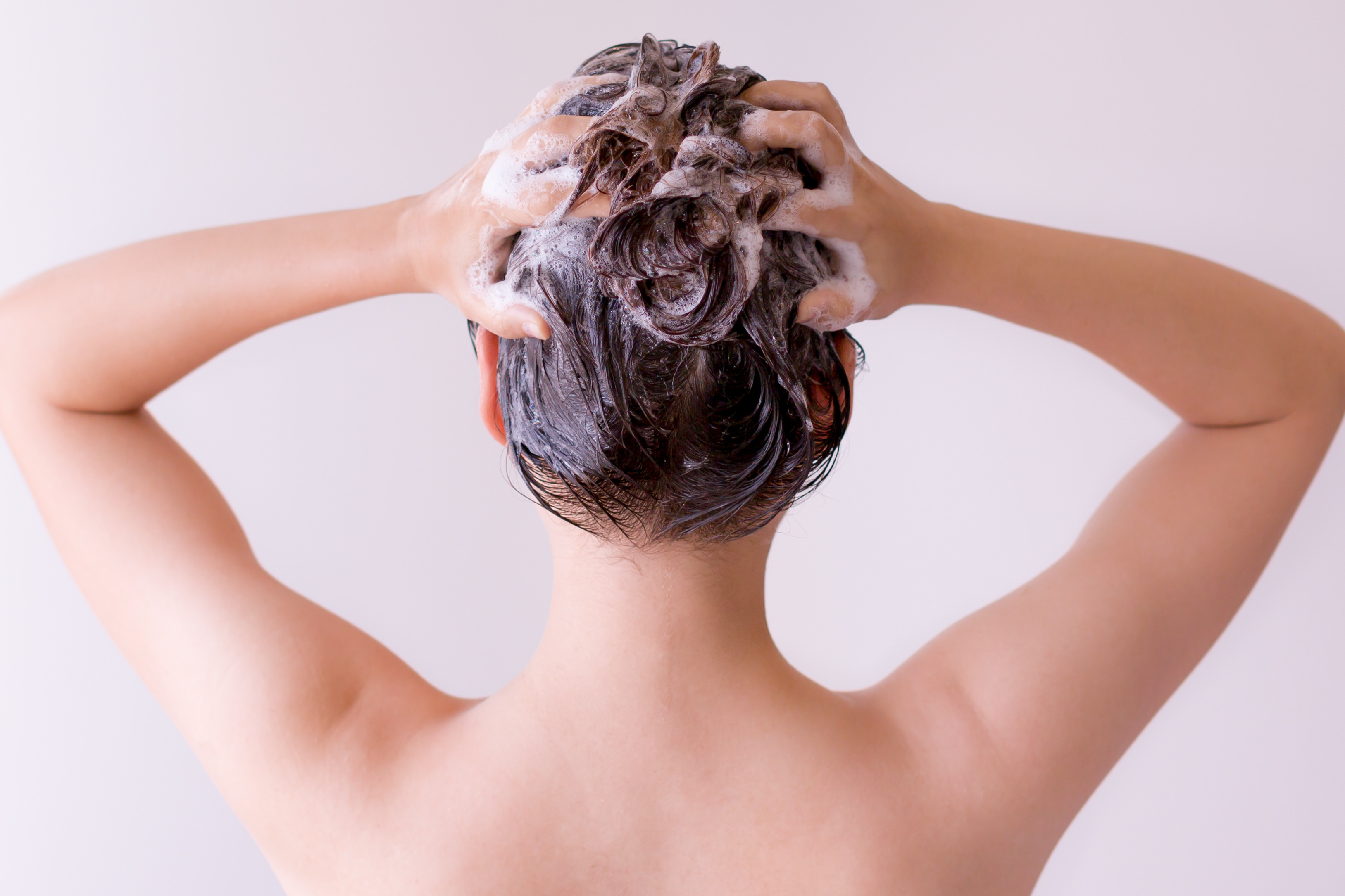 woman massaging foamy scalp
