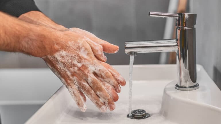 closeup of male hands washing with soap
