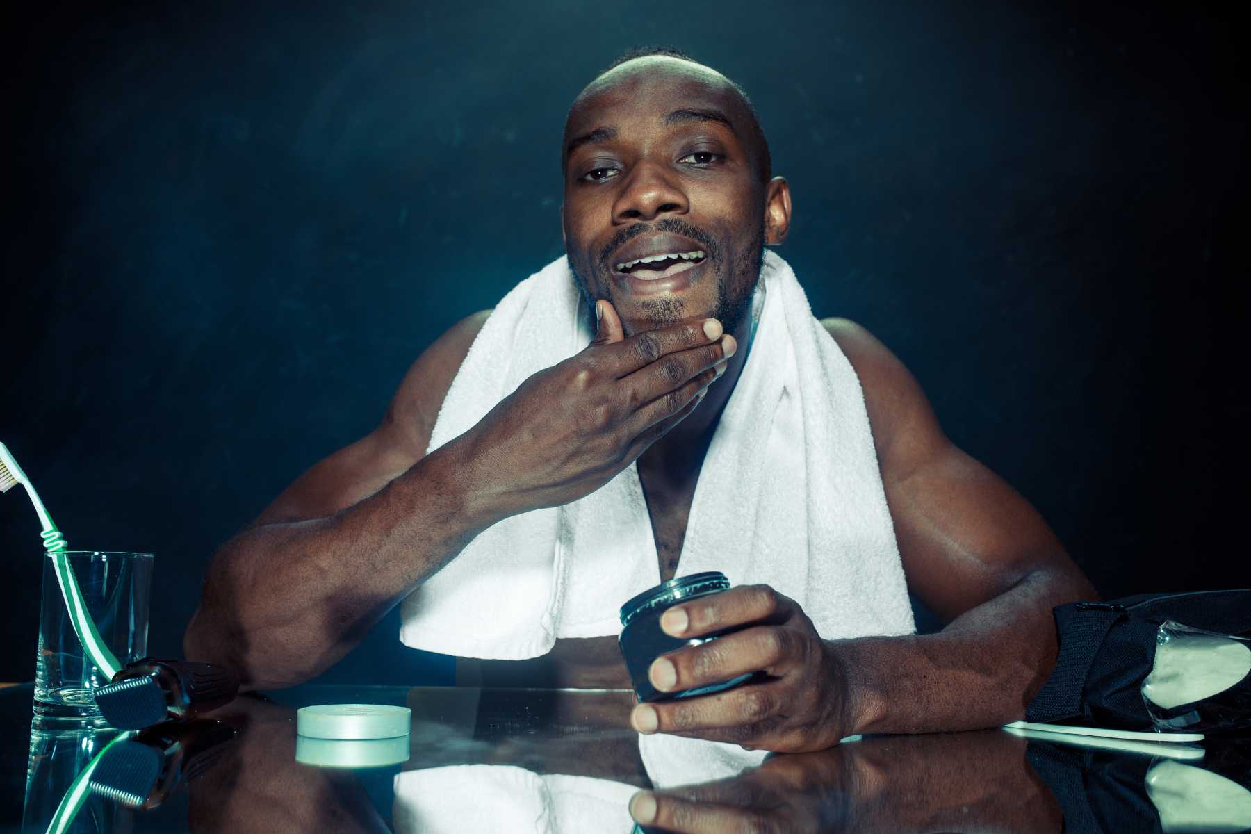 African American Man Applying After Shave to His Facee