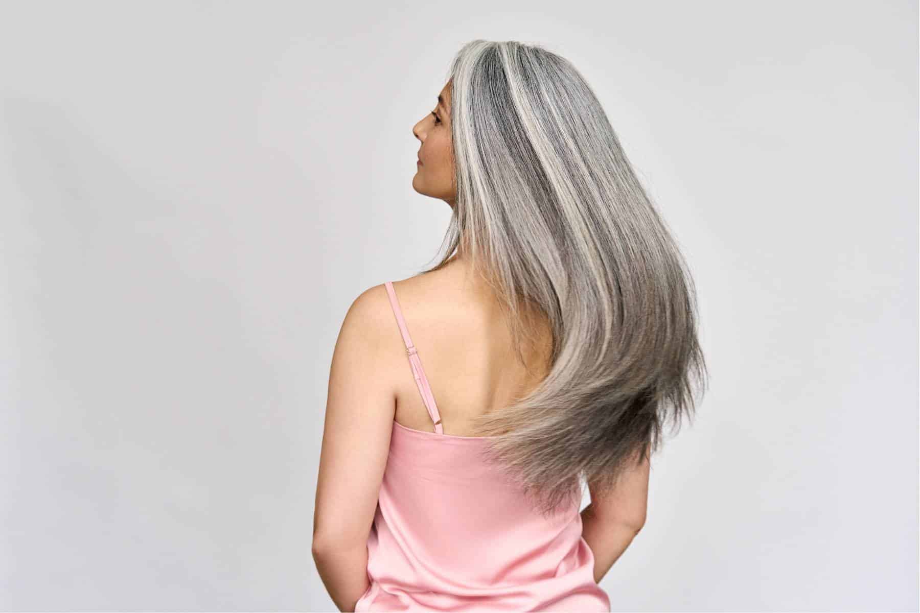 rear shot of a woman with long luxurious gray hair