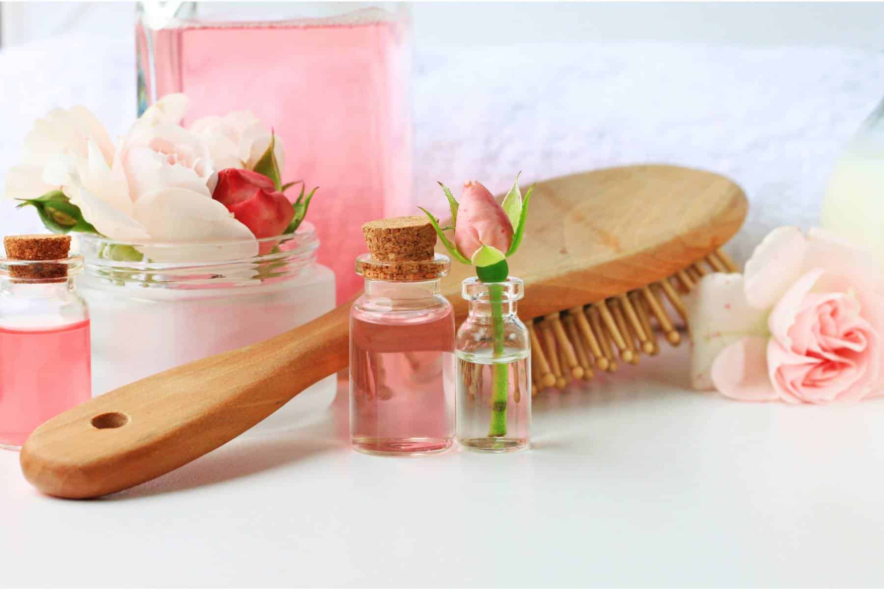 Rose water botanical hair products treatment, vials jars comb towel tonic home spa setting